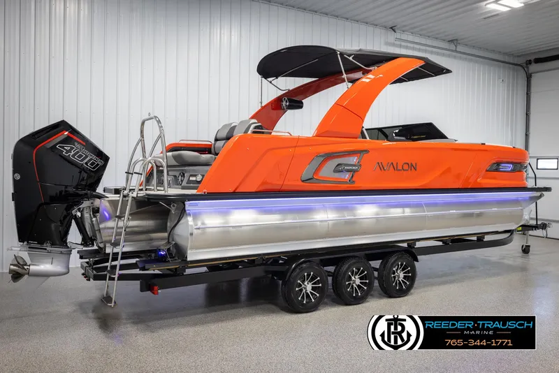 Slide: The Image of 2024 Avalon Excalibur VRB pontoon boat with orange exterior and black canopy. - 6