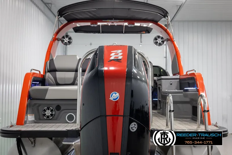 Slide: The Image of 2024 Avalon Excalibur VRB boat with red and black exterior, rear view. - 7