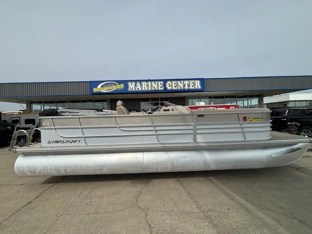 Slide: The Image of 2014 Starcraft Limited 236 pontoon boat at a marine center. - 1