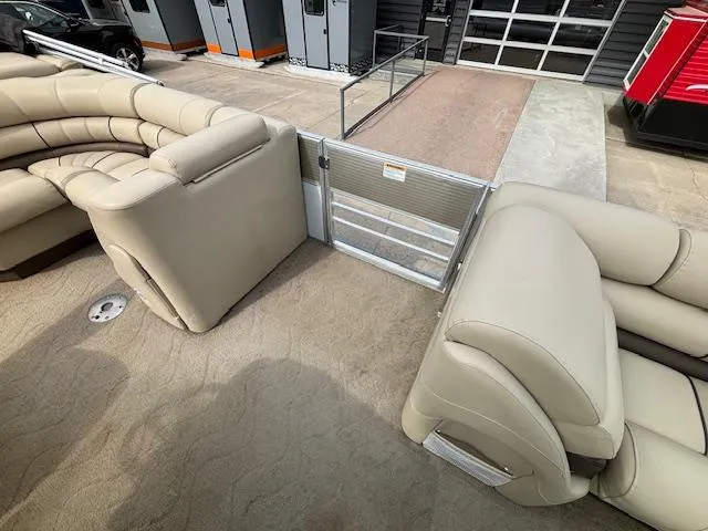 Slide: The Image of 2014 Starcraft Limited 236 pontoon boat interior with beige seating and carpet. - 10