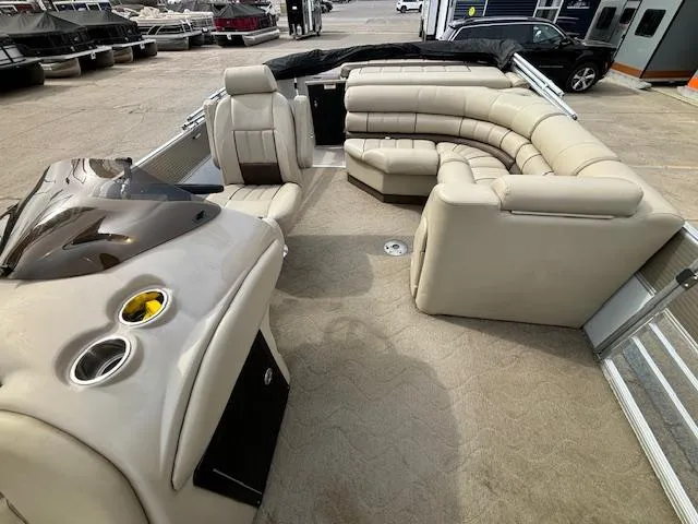 Slide: The Image of 2014 Starcraft Limited 236 pontoon boat with beige seating and helm. - 12
