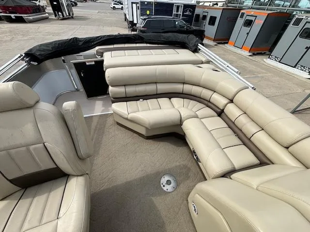 Slide: The Image of 2014 Starcraft Limited 236 boat with beige leather seating and spacious interior. - 14