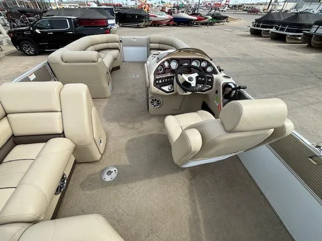 Slide: The Image of 2014 Starcraft Limited 236 pontoon boat interior with beige seating and control console. - 17