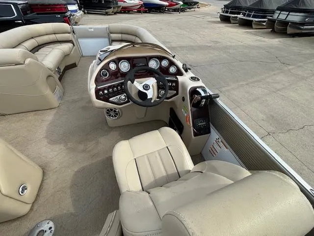 Slide: The Image of 2014 Starcraft Limited 236 boat interior with beige seating and control panel. - 18