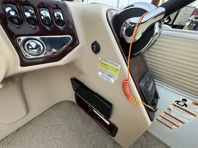 Slide: The Image of 2014 Starcraft Limited 236 boat dashboard with steering wheel and control panel. - 20
