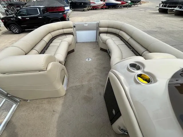 Slide: The Image of 2014 Starcraft Limited 236 pontoon boat with beige seating and cup holders. - 23