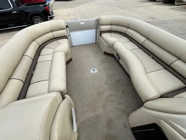 Slide: The Image of 2014 Starcraft Limited 236 pontoon boat with spacious beige seating. - 24