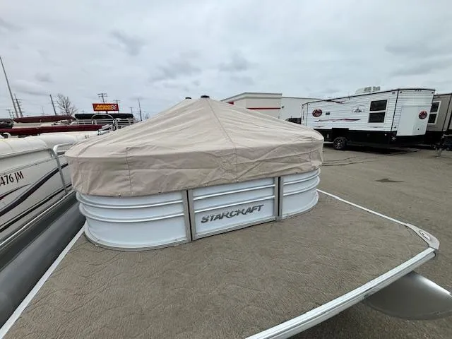 Slide: The Image of 2014 Starcraft Limited 236 pontoon boat with cover in parking lot. - 26