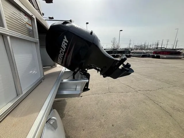 Slide: The Image of 2014 Starcraft Limited 236 with Mercury outboard motor in a parking lot. - 3