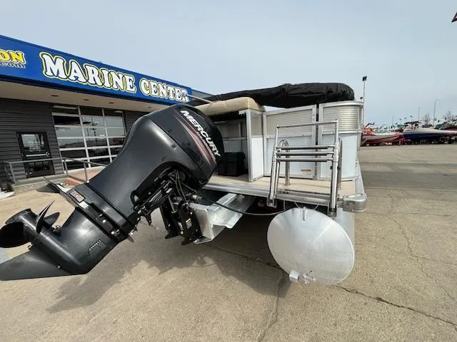 Slide: The Image of 2014 Starcraft Limited 236 pontoon boat with Mercury outboard motor at a marine center. - 5