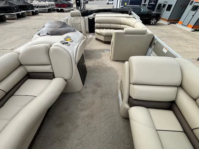 Slide: The Image of 2014 Starcraft Limited 236 pontoon boat with beige seating and spacious layout. - 8