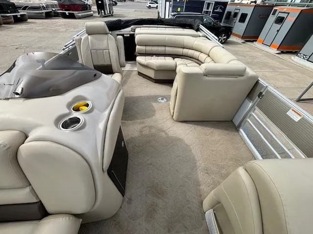 Slide: The Image of 2014 Starcraft Limited 236 boat interior with beige seating and cup holders. - 9
