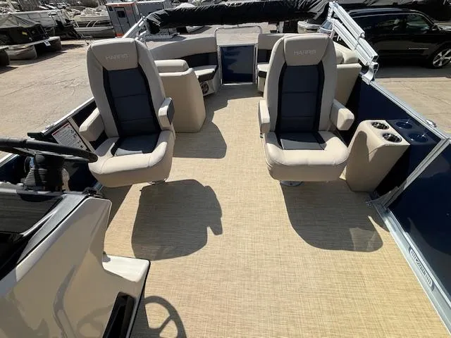 Slide: The Image of 2024 Harris Cruiser 230 CWDH boat interior with beige and black seating. - 10