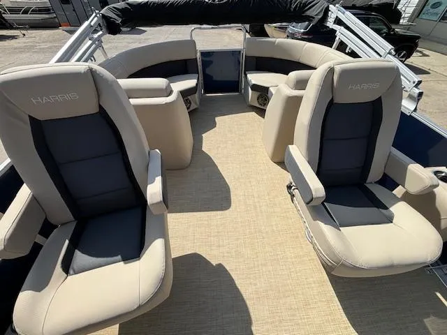Slide: The Image of 2024 Harris Cruiser 230 CWDH boat interior with beige and black seating. - 11