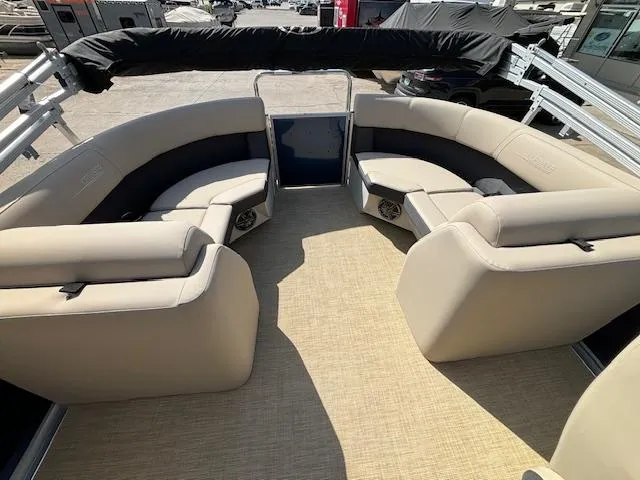 Slide: The Image of 2024 Harris Cruiser 230 CWDH pontoon boat with spacious seating and beige upholstery. - 12