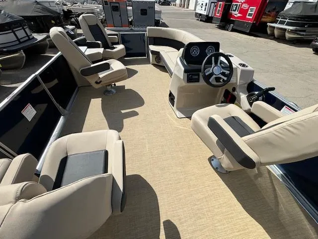 Slide: The Image of 2024 Harris Cruiser 230 CWDH pontoon boat interior with beige seating and steering console. - 16