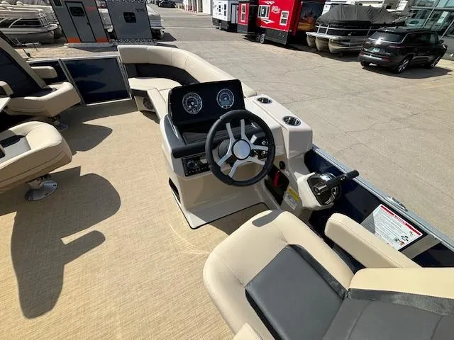 Slide: The Image of 2024 Harris Cruiser 230 CWDH boat interior with steering console and seating. - 17