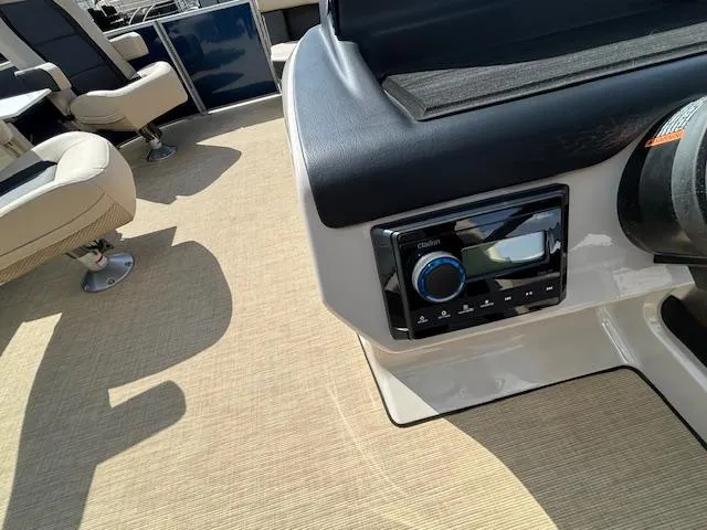 Slide: The Image of 2024 Harris Cruiser 230 CWDH boat interior with control panel and seating. - 19