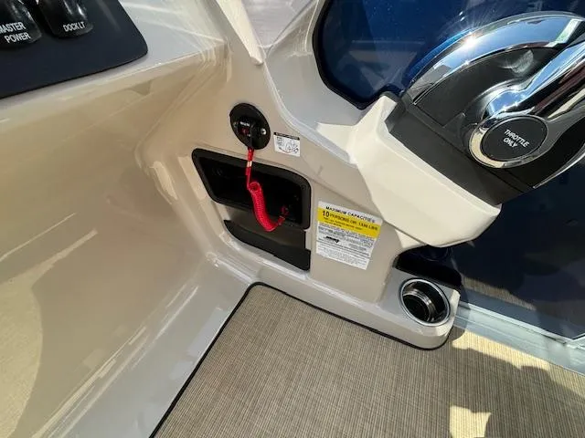 Slide: The Image of 2024 Harris Cruiser 230 CWDH boat interior control panel and ignition switch. - 20