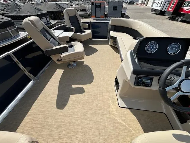 Slide: The Image of 2024 Harris Cruiser 230 CWDH pontoon boat interior with beige seating and modern dashboard. - 21