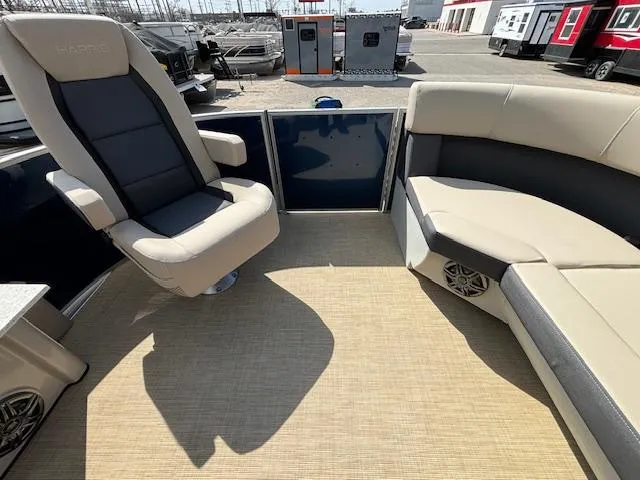 Slide: The Image of 2024 Harris Cruiser 230 CWDH boat interior with beige and black seating. - 24