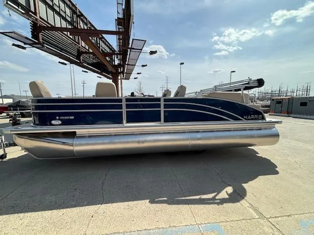 Slide: The Image of 2024 Harris Cruiser 230 CWDH pontoon boat in a parking lot under a clear sky. - 3