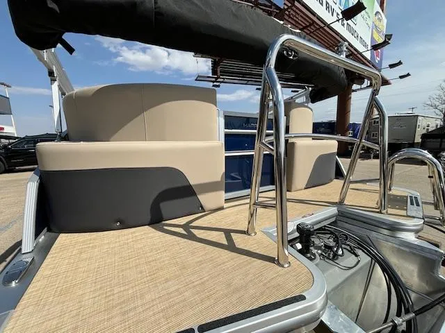 Slide: The Image of 2024 Harris Cruiser 230 CWDH pontoon boat with beige seating and stainless steel railings. - 4