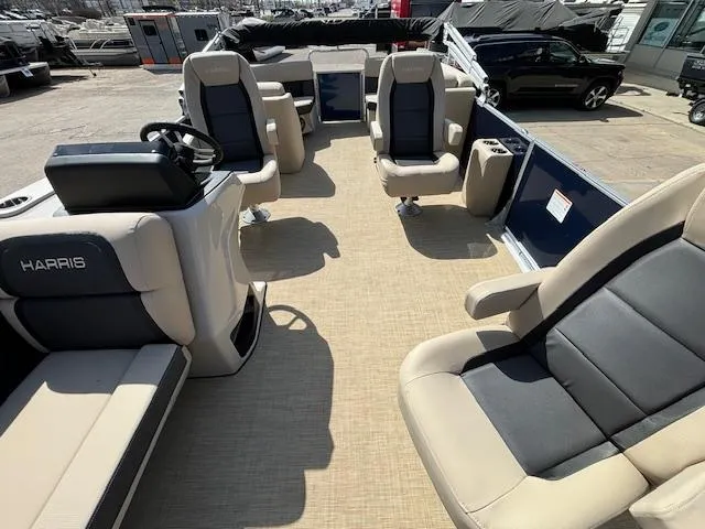 Slide: The Image of 2024 Harris Cruiser 230 CWDH pontoon boat interior with beige and black seating. - 9