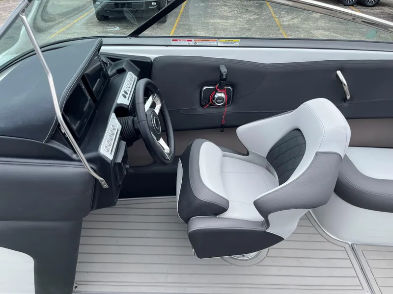 Slide: The Image of 2025 Crownline 240 SS boat interior with modern helm and captain's chair. - 7