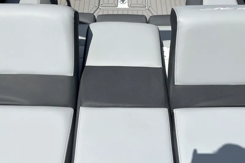 Slide: The Image of 2025 Crownline 220 SS boat with sleek, modern seating in black and white upholstery. - 2