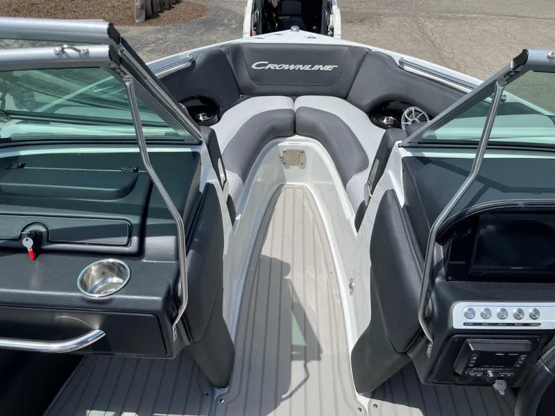 Slide: The Image of 2025 Crownline 220 SS boat interior with open bow seating and modern dashboard. - 4