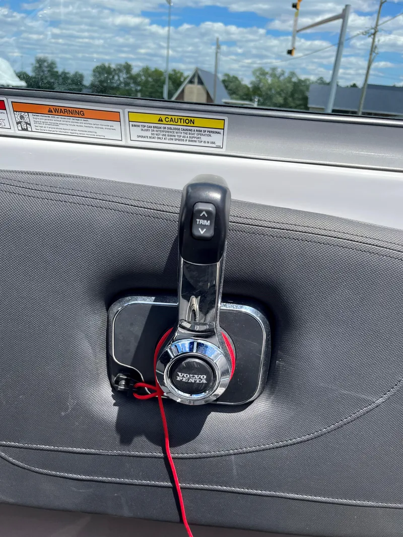 Slide: The Image of Throttle control of 2025 Crownline 220 SS boat with warning labels in background. - 9