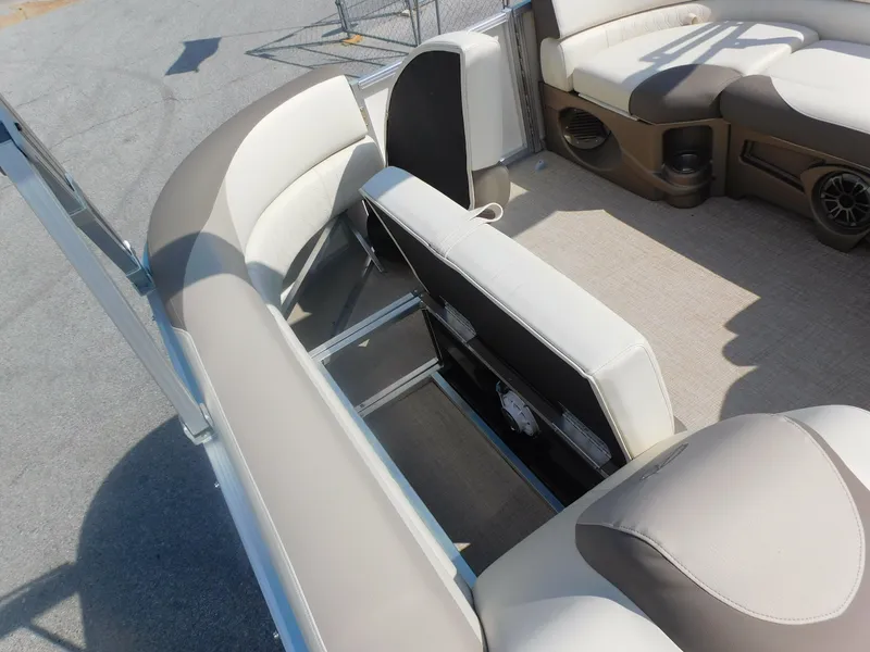 Slide: The Image of 2024 Avalon LSZ Quad Lounger boat interior with beige seating and storage compartments. - 11