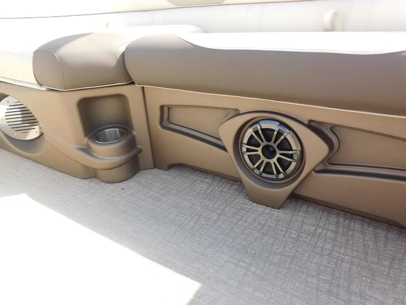 Slide: The Image of 2024 Avalon LSZ Quad Lounger interior with built-in speaker and cup holder. - 21