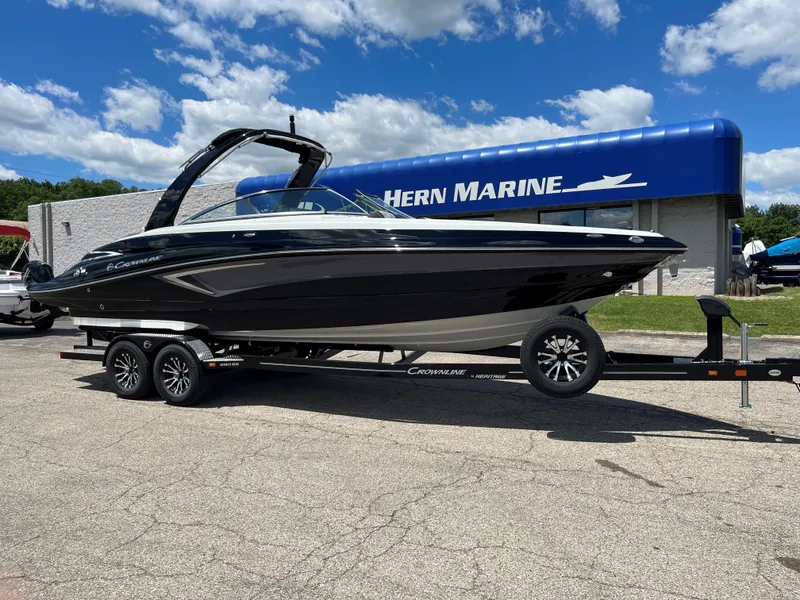 Slide: The Image of 2025 Crownline 290 SS boat on a trailer at Hern Marine dealership. - 0
