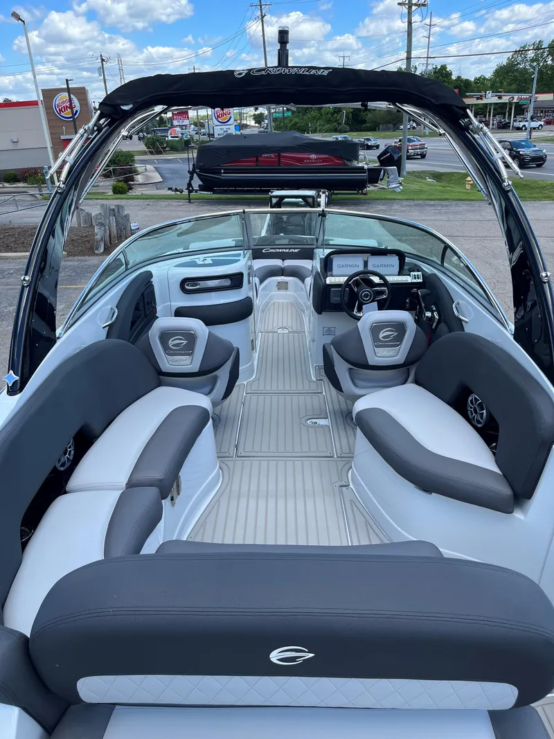 Slide: The Image of 2025 Crownline 290 SS boat interior with modern seating and dashboard. - 1