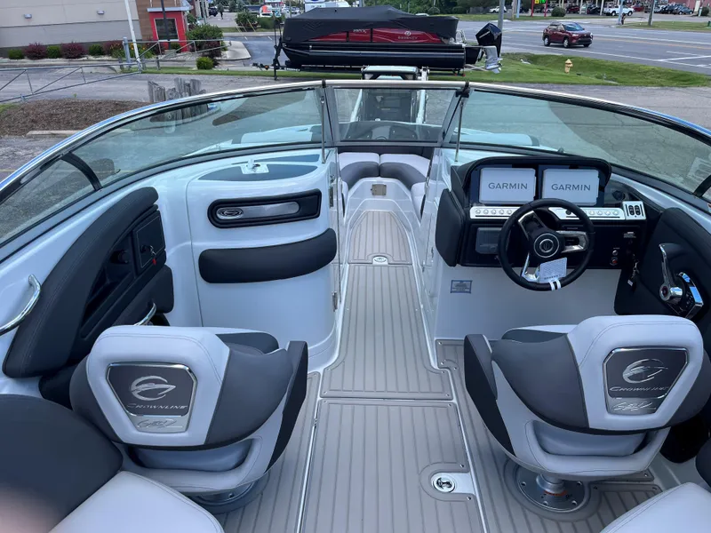 Slide: The Image of 2025 Crownline 290 SS boat interior with modern dashboard and seating. - 2