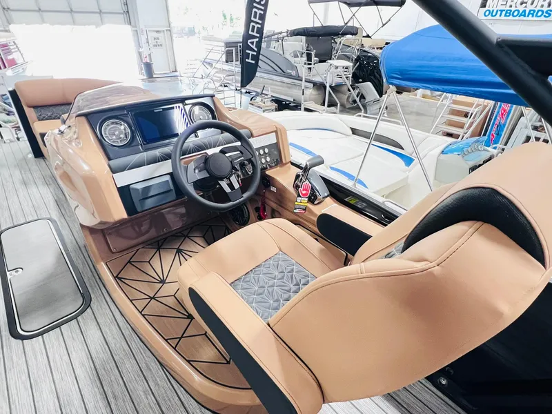 Slide: The Image of 2025 Harris Grand Mariner 230 boat interior with modern dashboard and tan seating. - 13