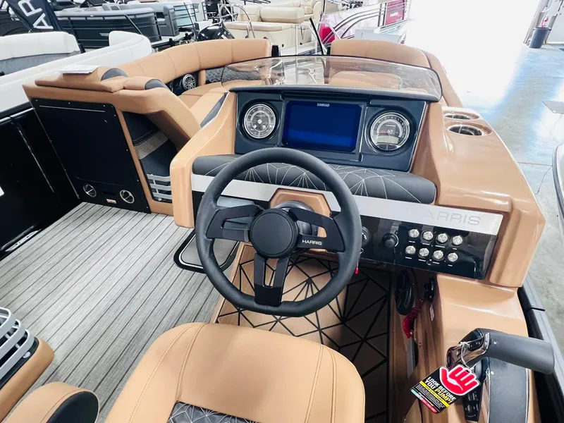 Slide: The Image of 2025 Harris Grand Mariner 230 boat interior with modern dashboard and steering wheel. - 14
