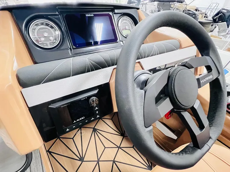 Slide: The Image of 2025 Harris Grand Mariner 230 dashboard with steering wheel and modern controls. - 15