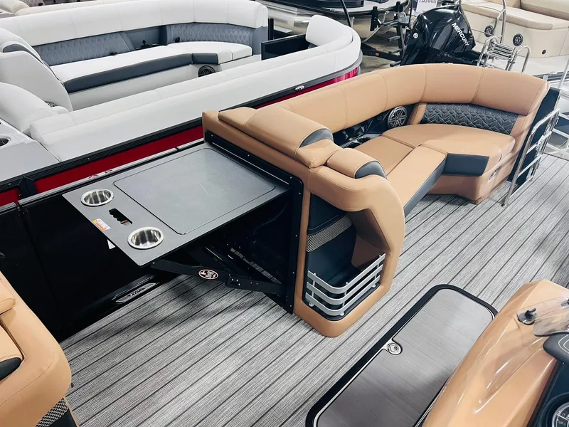 Slide: The Image of 2025 Harris Grand Mariner 230 interior with tan seating and table, featuring cup holders. - 18