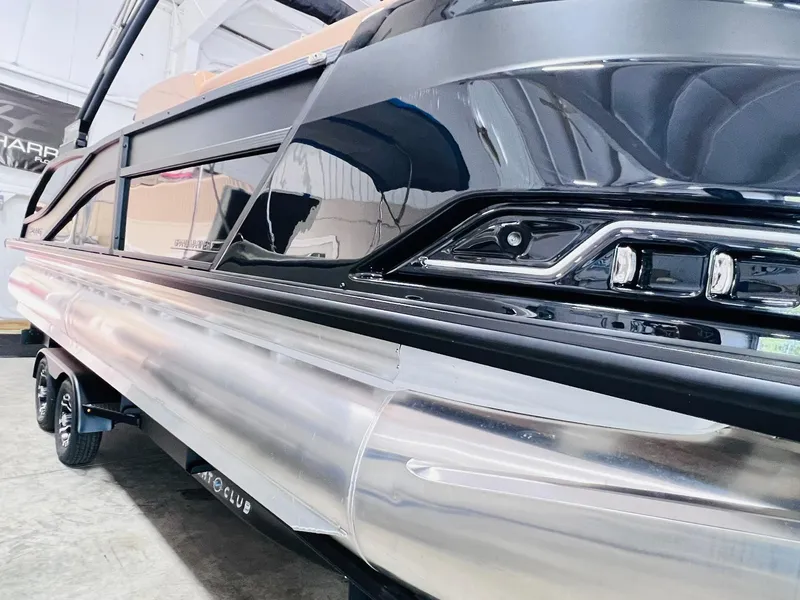 Slide: The Image of 2025 Harris Grand Mariner 230 pontoon boat, sleek design, black and silver finish. - 23