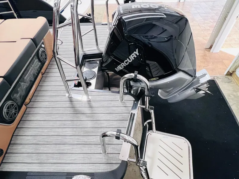 Slide: The Image of 2025 Harris Grand Mariner 230 boat with Mercury engine and sleek deck design. - 26