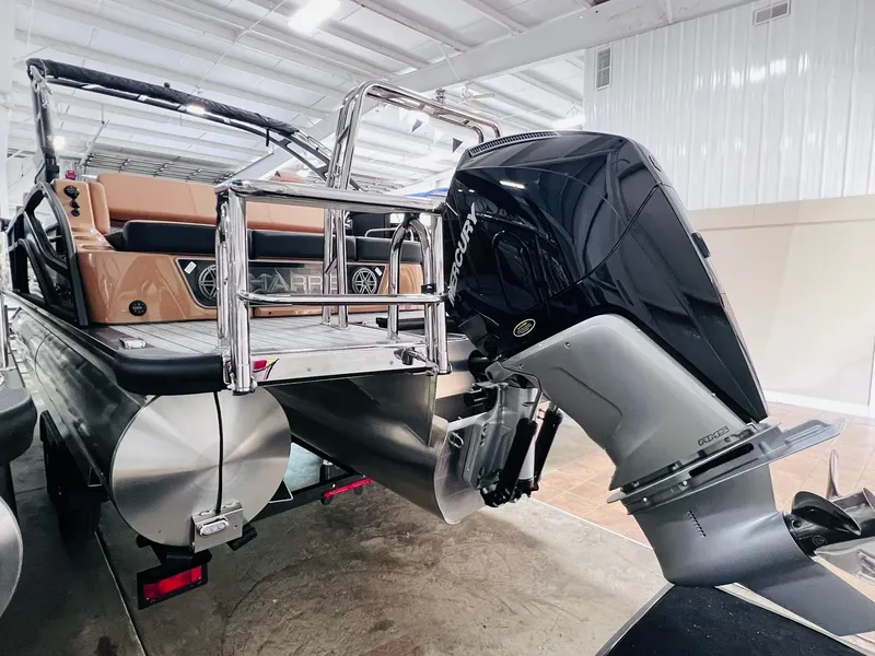 Slide: The Image of 2025 Harris Grand Mariner 230 pontoon boat with powerful outboard motor in showroom. - 27