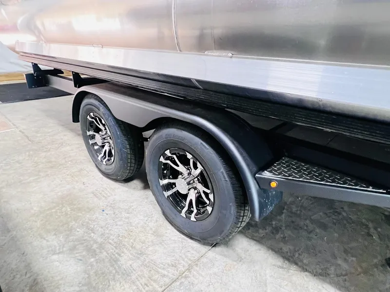 Slide: The Image of 2025 Harris Grand Mariner 230 trailer with dual wheels and sleek design. - 34