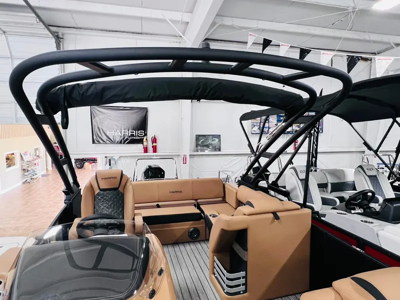 Slide: The Image of 2025 Harris Grand Mariner 230 pontoon boat interior with tan seating and black canopy. - 4