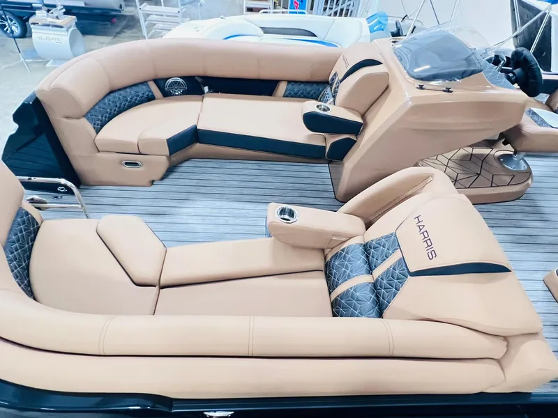 Slide: The Image of 2025 Harris Grand Mariner 230 boat interior with luxurious tan seating and modern design. - 6