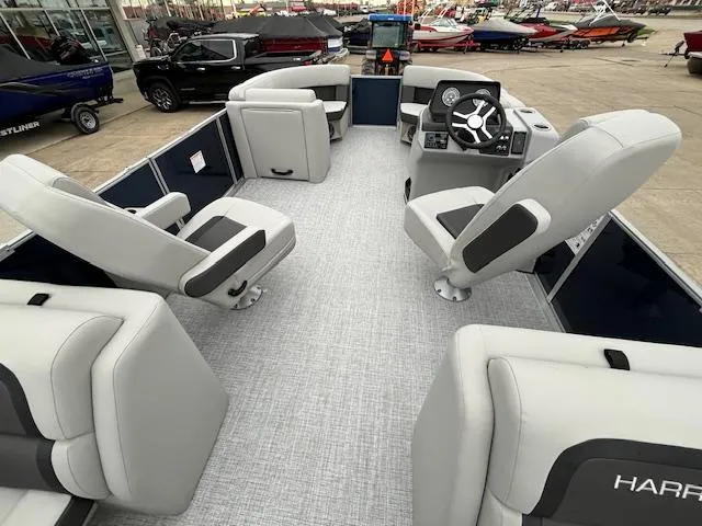 Slide: The Image of 2024 Harris Cruiser 210 CWDH pontoon boat interior with plush seating and modern helm. - 16