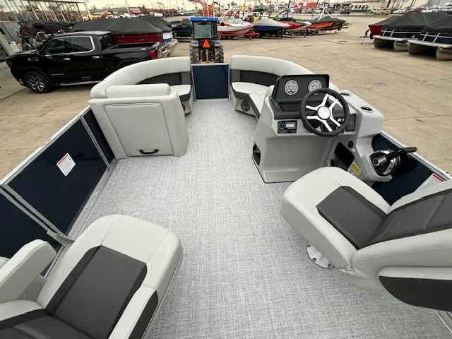 Slide: The Image of 2024 Harris Cruiser 210 CWDH pontoon boat interior with modern seating and steering console. - 17