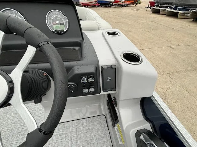 Slide: The Image of 2024 Harris Cruiser 210 CWDH boat dashboard with steering wheel and control panel. - 18